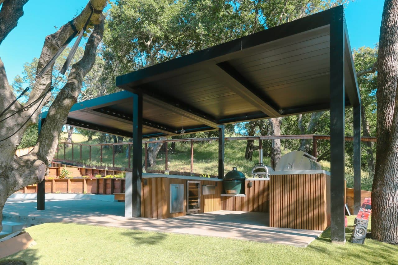 Custom outdoor kitchen with BBQ island and dining area
